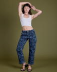 Alex is wearing Lazy Daisy Mid-Rise Carpenter Jeans and vintage tee white Cropped Tank