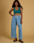 Kandia is wearing Contrast Stitch Mini Tank in Hunter Green and light wash Denim Drop Pocket Pants