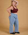 Side view of Mini Tank in Red Wine and light wash Indigo Wide Leg Trousers on Juliet