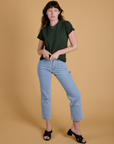 Alex is wearing Organic Vintage Tee in Swamp Green and light wash Carpenter Jeans
