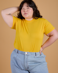 Ashley is wearing Organic Vintage Tee in Sunshine Yellow tucked into light wash Indigo Wide Leg Trousers