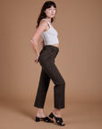 Side view of Organic Work Pants in Espresso Brown and vintage tee white Cropped Tank on Alex