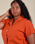 Angled front view of Pantry Button-Up in Chili Red on Meghna