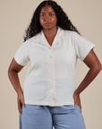 Meghna is wearing a buttoned up Pantry Button-Up in Vintage Tee White