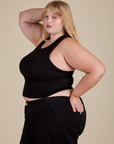 Racerback Tank in Black angled front view of Racerback Tank in Black on Juliet