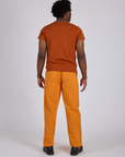 Back view of Work Pants in Creamsicle Orange and burnt terracotta Organic Vintage Tee on Isaac