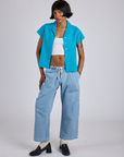 Kira is wearing Pantry Button-Up in Hawaiian Blue and light wash Denim Drop Pocket Pants