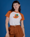 Alex is wearing Produce Raglan Tee in Habanero