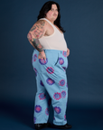 Side view. of Floral Painted Work Pants in Blue and Tank Top in Vintage Tee White