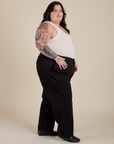 Side view of Work Pants in Basic Black and Tank Top in Vintage Tee Off-White on Sam