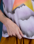 Alex is holding the hem of Airbrush Star Vintage Tee
