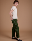 Side view of Carpenter Jeans in Evergreen and Organic Vintage Tee on Quinn