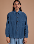 Anthony is wearing a buttoned up Cropped Corduroy Overshirt in French Blue