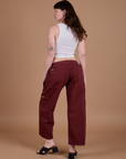 Angled back view of Drop Pocket Cargo Pants in Red Wine on Alex