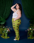 Side view of Paintstamped Work Pants in Froggy and vintage tee white Cropped Tank