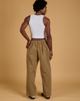 Back view of Baggy Mid-Rise Trousers in Desert Brown and vintage tee white Cropped Tank on Jerrod