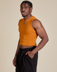 Angled front view of Muscle Tee in Creamsicle Orange on Isaac