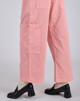 Close up of Drop Pocket Cargo Pants in Baby Pink pant legs on Kira