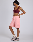 Angled front view of Longline Work Shorts in Baby Pink and red wine Mini Tank