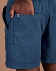Close up of Isaac's hand in the back pocket of Classic Work Shorts in French Blue