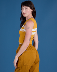 Painted Muscle Tee in Mustard Yellow side view on Alex