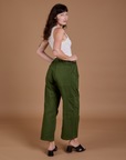 Angled back view of Drop Pocket Cargo Pants in Evergreen on Alex