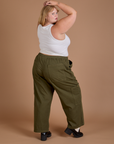 Angled back view of Drop Pocket Cargo Pants in Surplus Green and Cropped Tank in Vintage Tee White