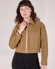 Alex is wearing a zipped up Mechanic Jacket in Desert Brown
