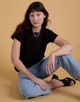 Alex is wearing Organic Vintage Tee in Basic Black and light wash Carpenter Jeans