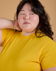 Angled front view close up of Organic Vintage Tee in Sunshine Yellow on Ashley