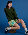 Longline Work Shorts in Spring Quilt Print and evergreen Long Sleeve Burly Tee on Alex