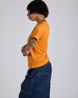 Jr. Varsity Tee in Creamsicle Orange side view on Kira