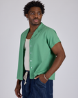 Angled front view of Pantry Button-Up in Seafoam Green on Isaac