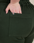 Close up of Ashley's hand in the back pocket of Short Sleeve Jumpsuit in Swamp Green