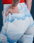 Close up of Alex's hand in the back pocket of Work Pants in Sunny Cloud Airbrush