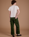 Back view of Carpenter Jeans in Evergreen and the Organic Vintage Tee in Vintage Tee Off-White on Quinn