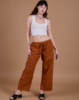 Alex is 5’8” and wearing XXS Drop Pocket Cargo Pants in Burnt Terracotta paired with a vintage tee white Cropped Tank