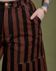 Close up of Sydney's hand in the front pocket of Longline Work Shorts in Fudgesicle Brown