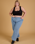 Juliet is wearing Mini Tank in Basic Black and light wash Indigo Wide Leg Trousers