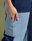 Close up of Tiara's hand in the side leg pocket of Mismatched Denim Carpenter Jeans