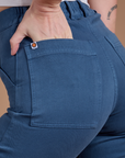 Close up of Alex's hand in the back pocket of Organic Work Pants in French Blue