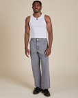 Isaac is 5’10” and wearing S Racerback Tank in Vintage Tee White paired with washed grey Work Pants