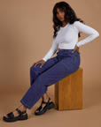 Kandia is wearing Railroad Denim Work Pants in Faded Grape Overdye and Long Sleeve Baby Tee in Vintage Tee White