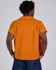 Pantry Button-Up in Creamsicle Orange back view on Isaac