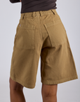 Longline Work Shorts in Desert Brown back view on Kira
