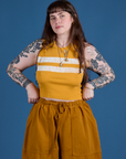 Sydney is 5’9” and wearing XXS Painted Muscle Tee in Mustard Yellow