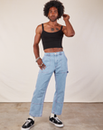 Jerrod is wearing Cropped Cami in Basic Black and light wash Carpenter Jeans