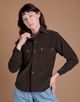 Alex is wearing a buttoned up Cropped Corduroy Overshirt in Espresso Brown