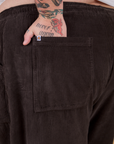 Close up of Sam's hand in the back pocket of Corduroy Drop Pocket Cargo Pants in Espresso Brown