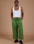 Isaac is 5’10” and wearing M Denim Drop Pocket Pants in Green Overdye paired with vintage tee white Cropped Tank